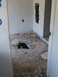 House with holes on the floor and the walls, damaged by City workers