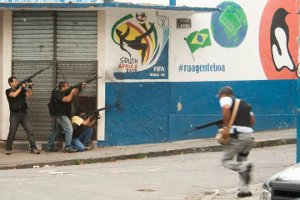 Police cover a street corner in front of the World Cup 2010 logo