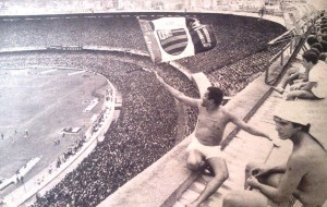 A Flamengo supporter waves the flag over a packed Maracanã