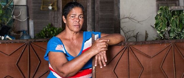 Guardian caption: Jane Nascimento de Oliveira, who is one of hundreds of residents fighting to save their homes from forced eviction for the 2016 Olympics, in Barra da Tijuca, Rio de Janeiro, Brazil. Photo by Lianne Milton/Guardian