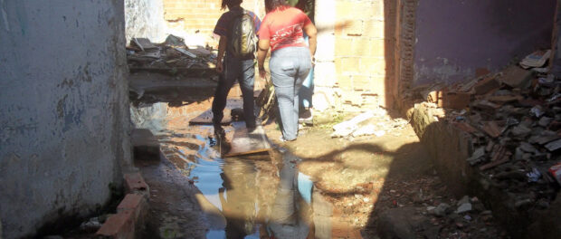 Sewage and stagnant water run between houses 