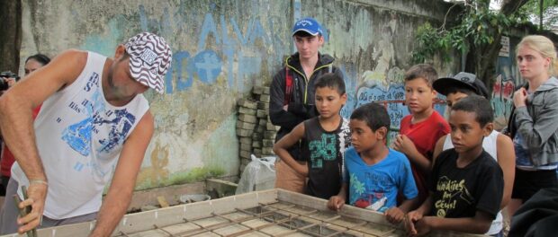 Community children anxiously watched as the Vila Autódromo ping pong table was built by residents