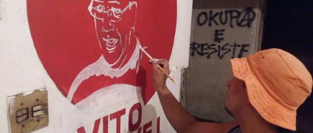 Occupier paints a portrait of Vito Gianotti, social movement leader after whom the occupation is named