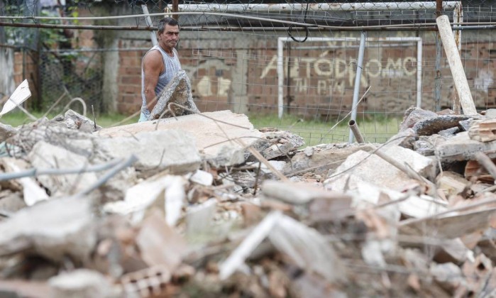 Altair Guimarães, president of the Residents’ Association, looking at the rubble of his former home. Photo by Alexandre Cassiano / Agência O Globo