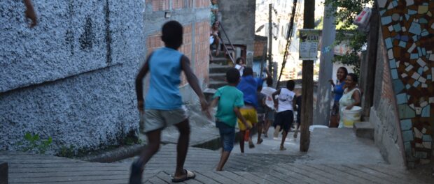 Children running down the streets of the favela