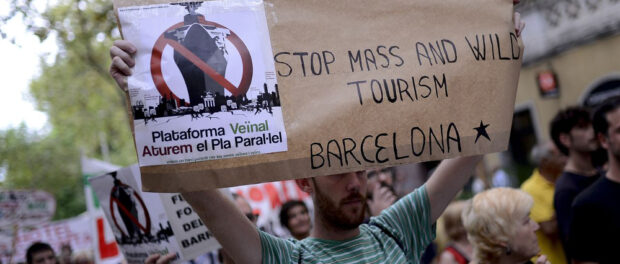Barcelona residents demonstrate against mass tourism in 2014, Barcelona. Photo by Josep Lago / Getty