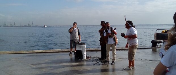 Members of indigenous communities perform songs about water and the bay