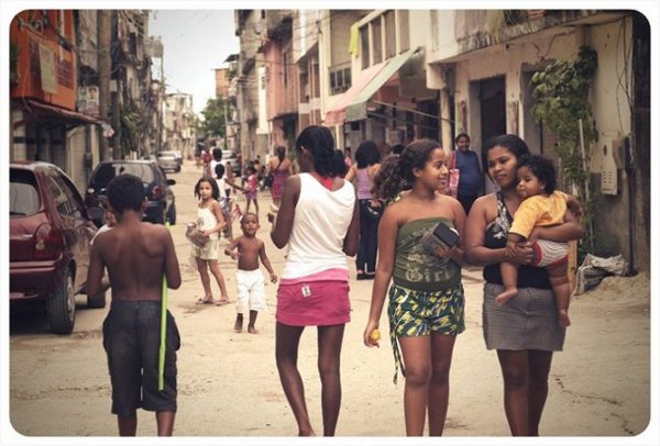 Residents walk on Rua Asa Branca