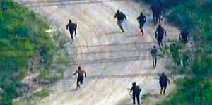 Globo TV image of drug traffickers fleeing the police occupation in Vila Cruzeiro and Alemão
