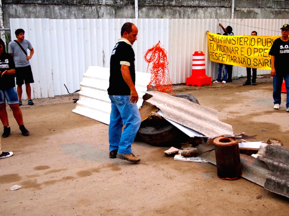 Residents create a barricade at Vila Autódromo to protest against evictions