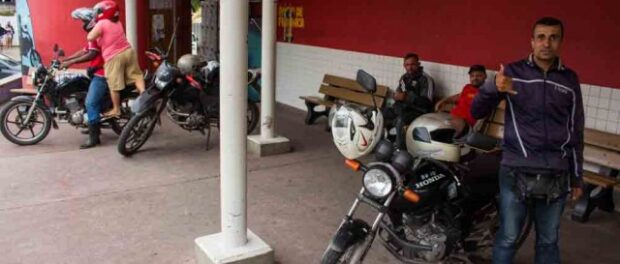 Motorbike taxi driver in Grota, Complexo do Alemão. Photo by Bento Fabio