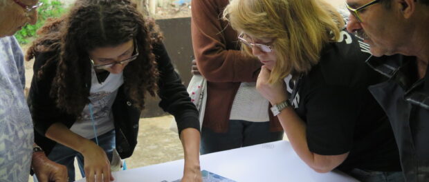 Nathalia explaining Federal University of Rio de Janeiro drone-produced map to fellow resident-resisters