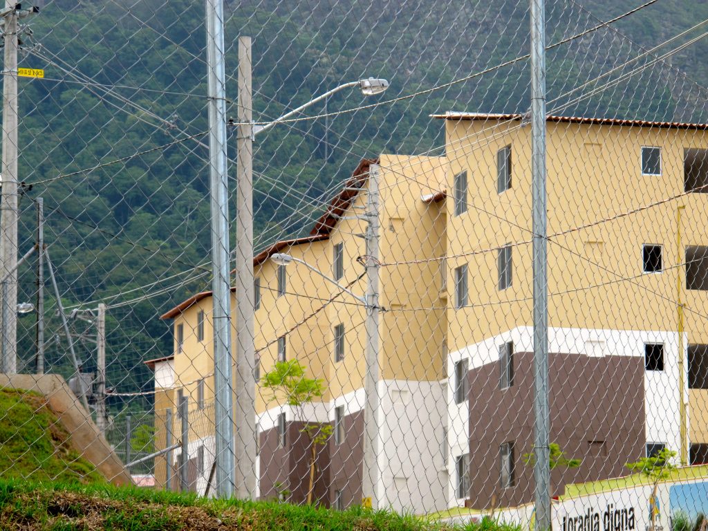 Chainlink fences separate the lots. To some they resemble prisons more than homes. Chainlink fences separate the lots. To some they resemble prisons more than homes.