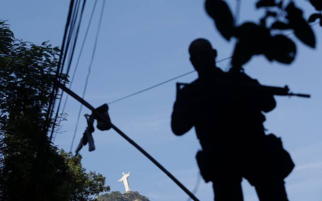 Police officers guards a UPP base in Rio. Photo by Ricardo Moraes/Reuters