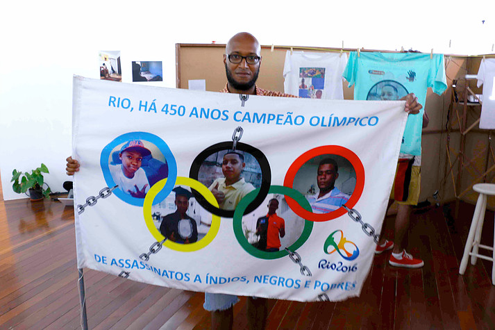 Artist Wagner Novais with his work: "Rio, Champion of killing indigenous, Black, and poor people for 450 years"