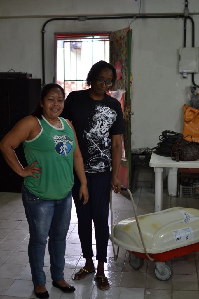 Denise Vieira (left) and Denise Francisca (right) with the book cart used for the monthly "Come Livros" event