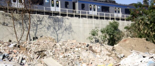 Piles of garbage and rubble lie under the train tracks in Beira Rio, Manguinhos.