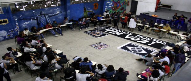 Activists place banners in front of panel on state violence, youth and racism. Photo by Natalie Southwick