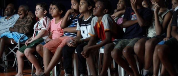 The emotion is palpable as community members watch their peers being celebrated on screen.