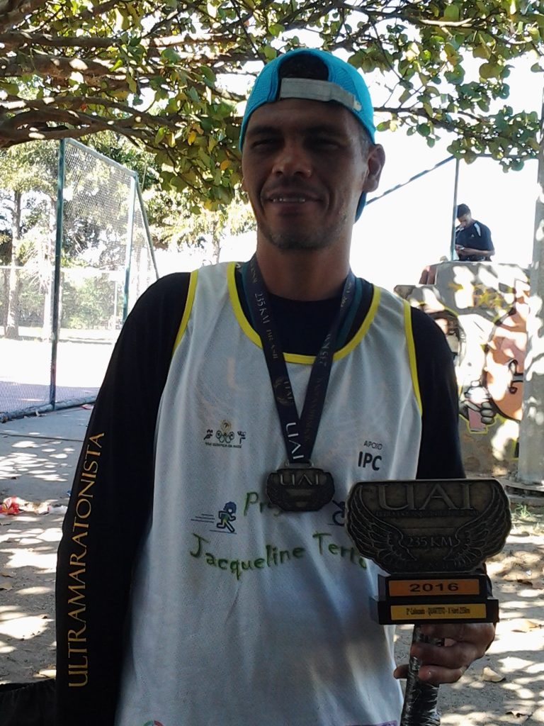 Edivandro with the medal and trophy he received for coming 2nd in the recent marathon