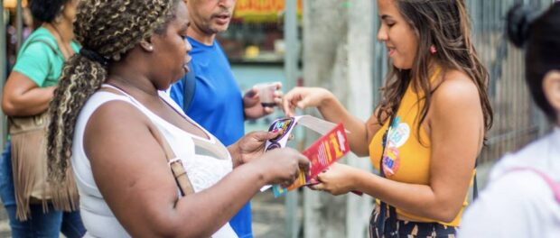 A volunteer campaigner for Freixo canvases in Rio's downtown