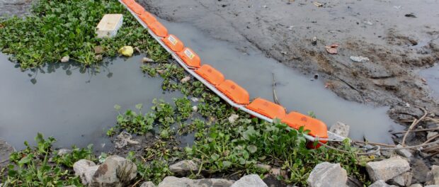 The eco-barrier consists of a floating plastic grid attached to a steel cord that stretches across the river. Photo by Sophia Zaia