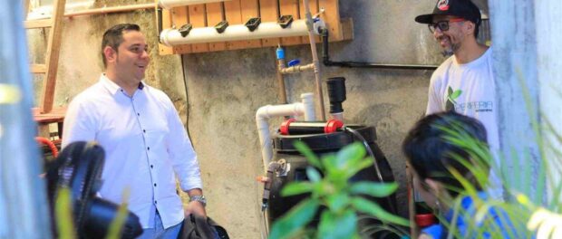 Fábio leads a tour through Favela da Paz, demonstrating the hydroponic system.