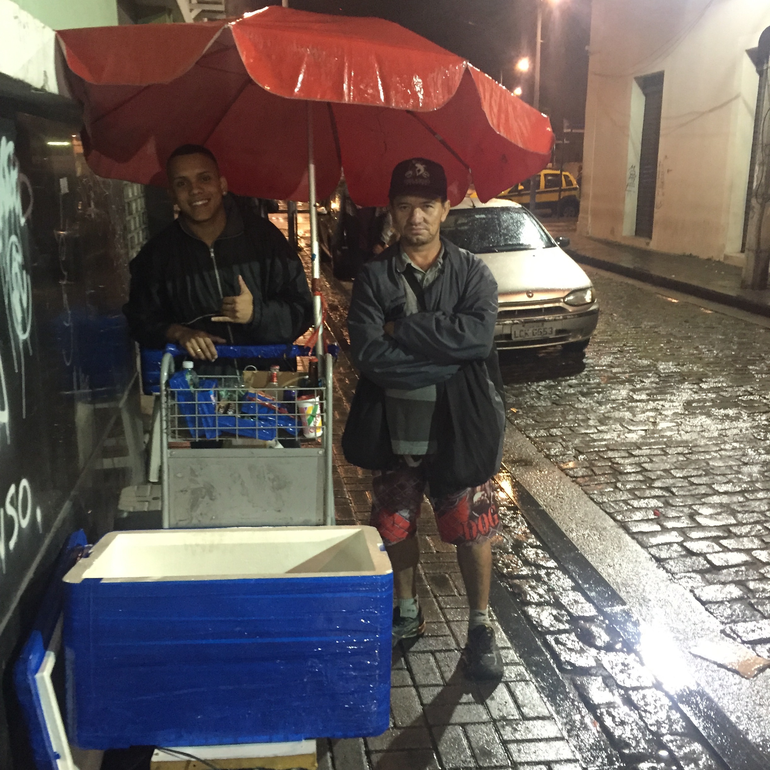 Extended Family Business: Gabriel (left) stores his product in the garage of Francis (right) in the favela of Providência. Francis’ wife is Gabriel’s fiancee’s aunt. Each Monday, Gabriel comes by train to Rio where he meets Francis in Providência and the two make the half hour trek together with their carts to Pedra do Sal. Extended Family Business: Gabriel (left) stores his product in the garage of Francis (right) in the favela of Providência. Francis’ wife is Gabriel’s fiancee’s aunt. Each Monday, Gabriel comes by train to Rio where he meets Francis in Providência and the two make the half hour trek together with their carts to Pedra do Sal.