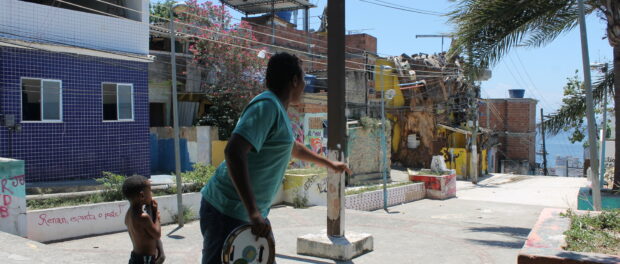 Cosme Felippsen holding a traditional samba instrument, the pandeiro