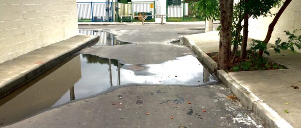 After rains, the community floods as it always has, despite hoping the asphalted streets would reduce standing water