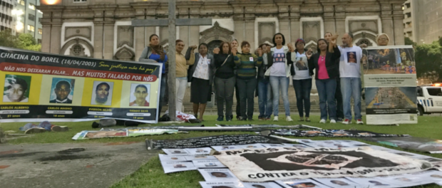 Mothers and family members of victims of police violence hold hands