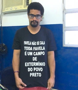 André Constantine displays shirt that says "Favela don't be quiet. Every favela is an extermination camp for black people."