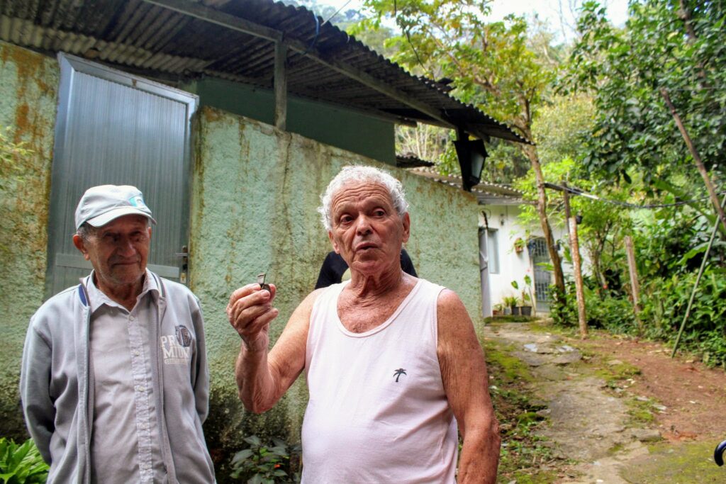 Seu Zeca holds his grandfather's whistle, who was one of the old guards of the Botanical Gardens.