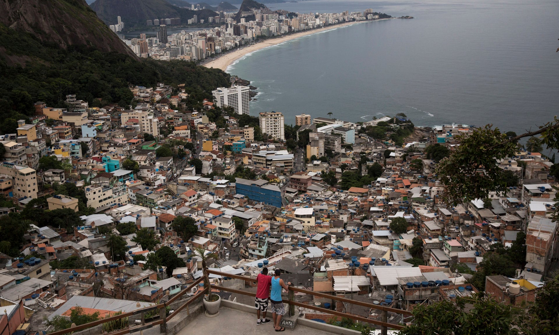 Men overlook the city from the Vidigal favela, in Rio de Janeiro, Brazil. Photograph: Renata Brito/AP