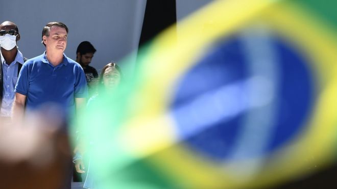 Bolsonaro observes supporters at a rally in Brasilia amid the coronavirus pandemic. Photo - Evaristo Sa, AFP