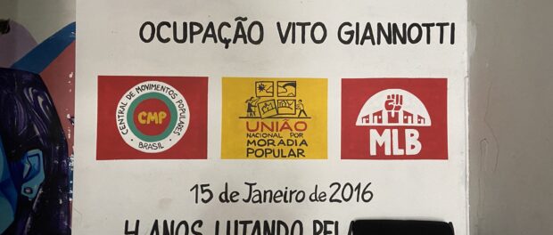 The entrance of the Vito Giannotti occupation with the symbols of the social movements fighting for housing and responsible for its organization